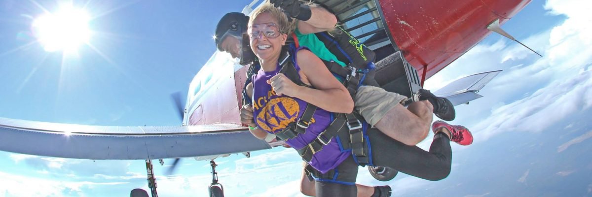 Two skydivers jump out of a plane.