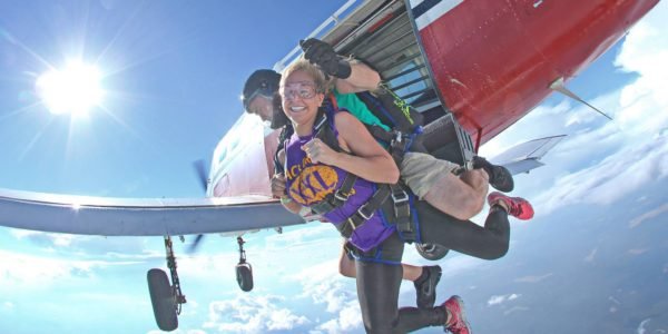 Two skydivers jump out of a plane.
