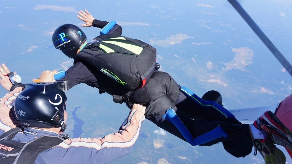 instructor guides learn to skydive student through exit and freefall
