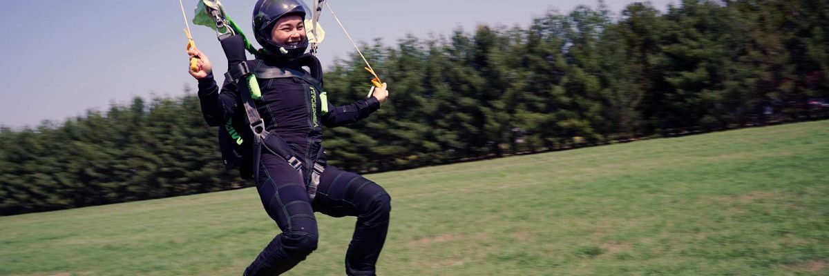 A skydiver lands after a jump.
