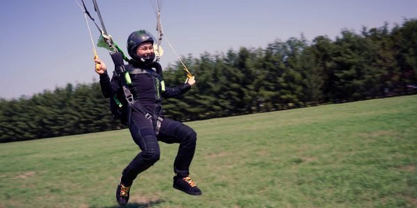 A skydiver lands after a jump.