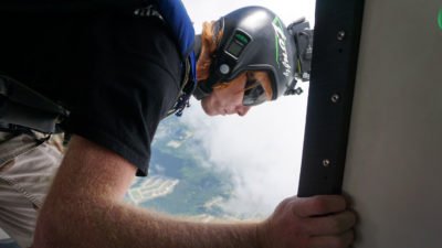 A skydiver exits the aircraft using an audible altimeter.
