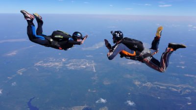 During a skydive, hand signals are used... you can't speak to each other during free fall. 