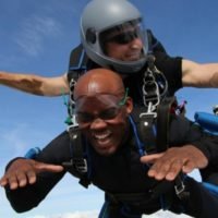 young man makes a tandem skydive