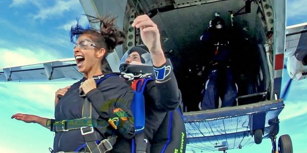 exit shot of woman tandem skydiving near Fayetteville