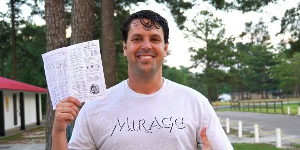 Paul holds up skydiving license