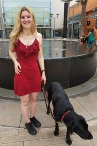 Shawnna in front of fountain with seeing eye dog