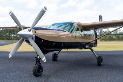 Skydive Paraclete XP's gold and black skydiving Caravan airplane.
