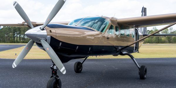 Skydive Paraclete XP's gold and black skydiving Caravan airplane.