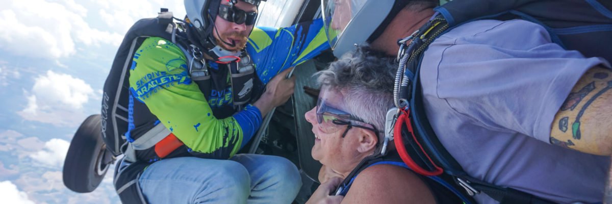 A skydiver prepares to jump from the plane.