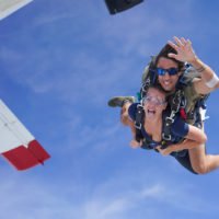 tandem skydivers exit airplane