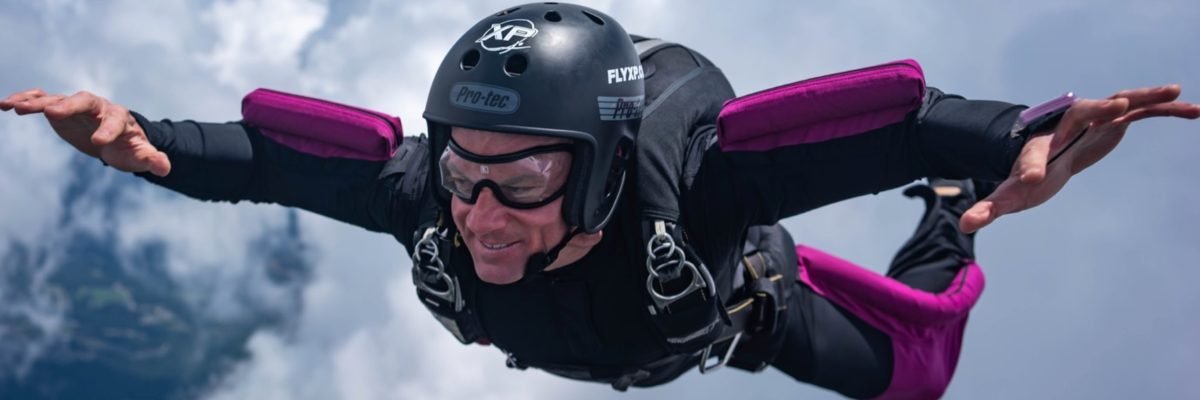experienced skydiver in freefall smiling while falling on their belly