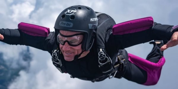 experienced skydiver in freefall smiling while falling on their belly