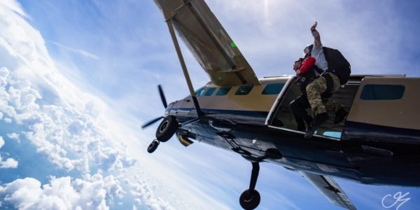 tandem skydivers exit airplane