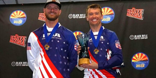 Smiling photo of Jason and Jake from XP Ascend after winning a medal.